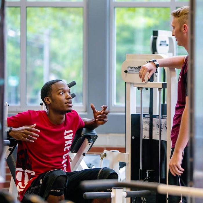 Two students talking in fitness center